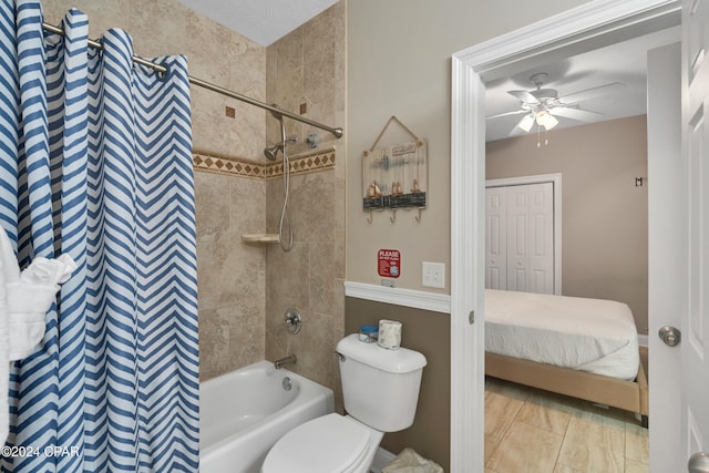 bathroom featuring tiled shower / bath combo, toilet, and ceiling fan