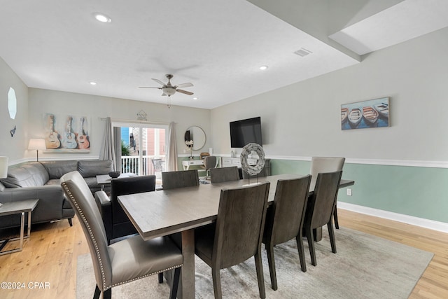 dining space with ceiling fan and light hardwood / wood-style floors