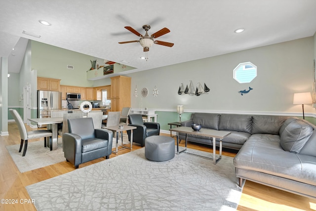 living room featuring light wood-type flooring and ceiling fan