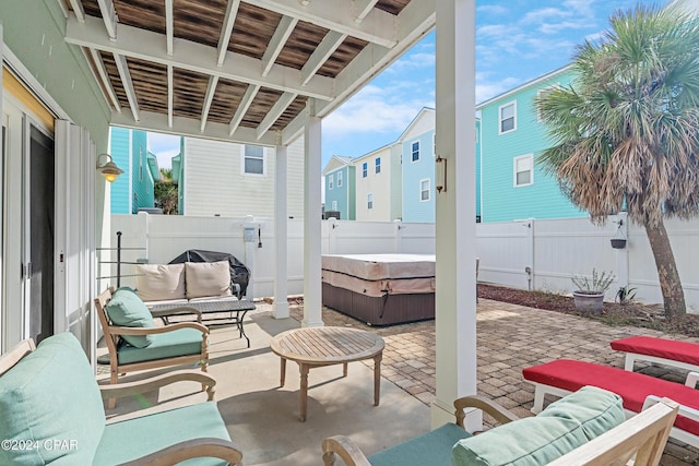 view of patio with an outdoor living space and a hot tub