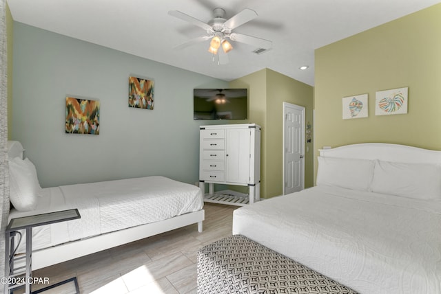 bedroom with ceiling fan and light hardwood / wood-style floors