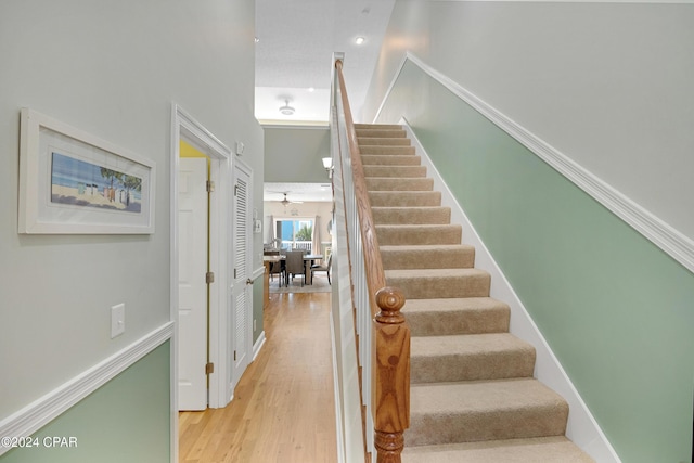 stairs featuring hardwood / wood-style floors