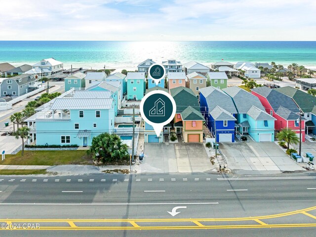 drone / aerial view featuring a water view and a beach view