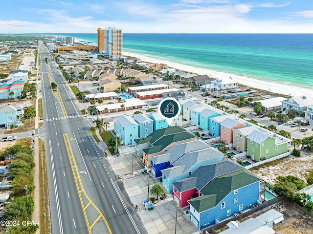 bird's eye view featuring a water view and a beach view