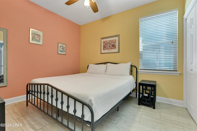 bedroom featuring ceiling fan and a closet