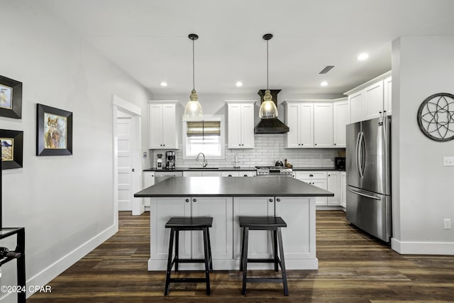 kitchen featuring pendant lighting, dark hardwood / wood-style floors, white cabinetry, and stainless steel appliances