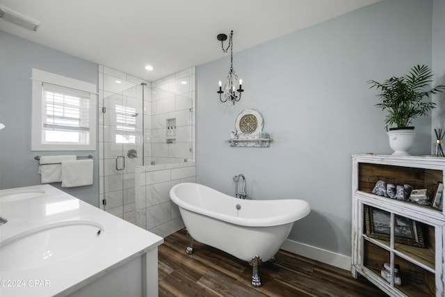 bathroom featuring plus walk in shower, wood-type flooring, vanity, and a chandelier