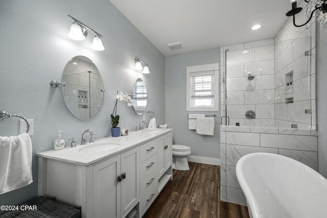 full bathroom featuring hardwood / wood-style flooring, vanity, toilet, and shower with separate bathtub