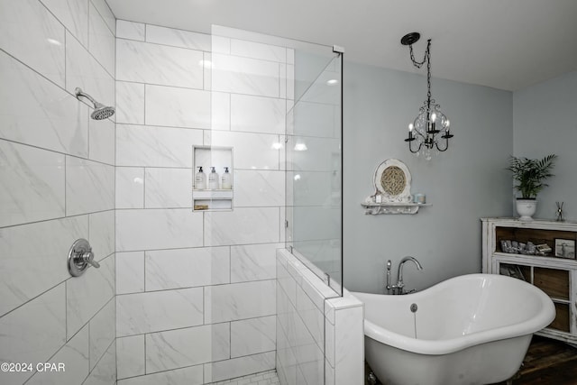 bathroom with independent shower and bath and a chandelier