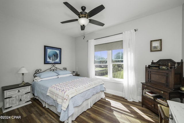 bedroom with ceiling fan and dark wood-type flooring