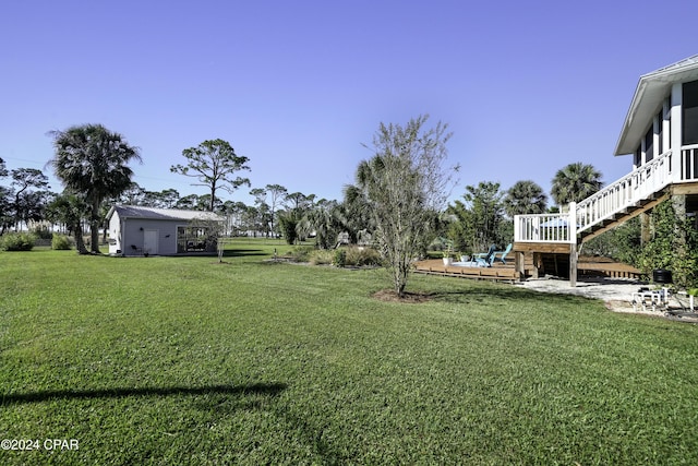 view of yard with an outbuilding and a wooden deck