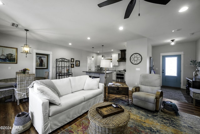 living room with ceiling fan and dark hardwood / wood-style floors