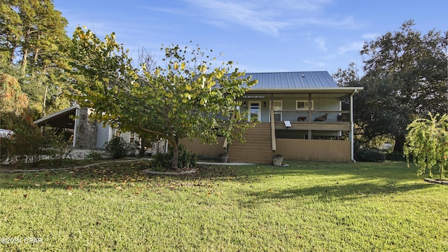 rear view of house featuring a lawn