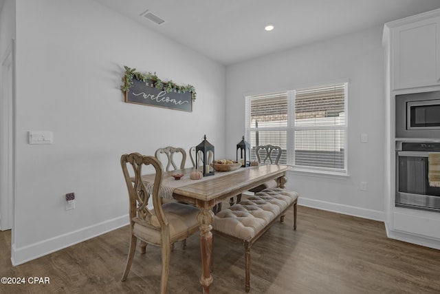 dining space with dark hardwood / wood-style flooring