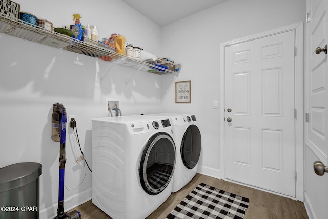 laundry room with hardwood / wood-style floors and washer and dryer