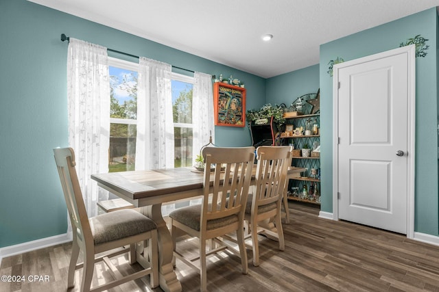 dining space with dark wood-type flooring