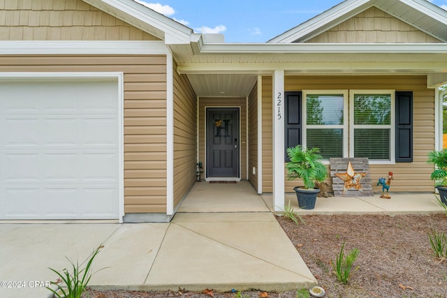 entrance to property with a porch and a garage