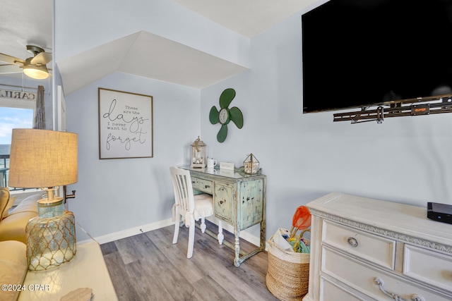 office area with ceiling fan, vaulted ceiling, and light wood-type flooring