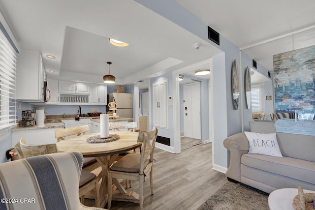 dining area featuring light hardwood / wood-style flooring and sink