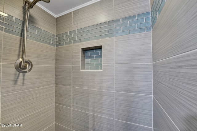 bathroom with a shower and crown molding