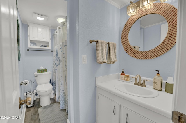 bathroom featuring crown molding, toilet, vanity, and hardwood / wood-style flooring