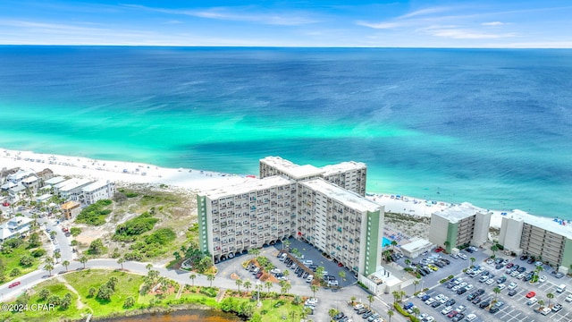 drone / aerial view with a water view and a beach view