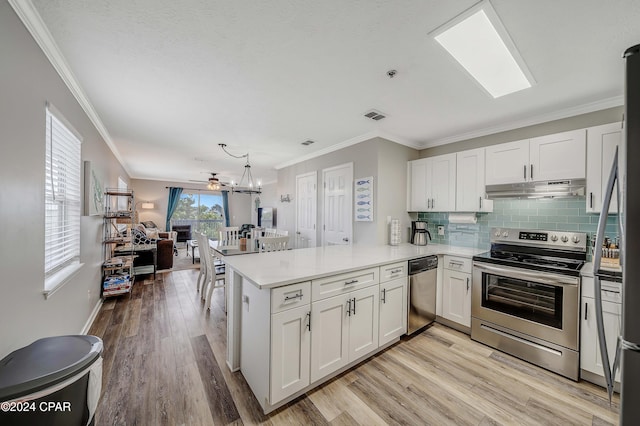 kitchen with white cabinets, stainless steel appliances, and dark hardwood / wood-style floors