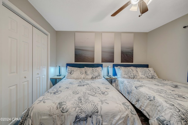 bedroom with ceiling fan and a closet