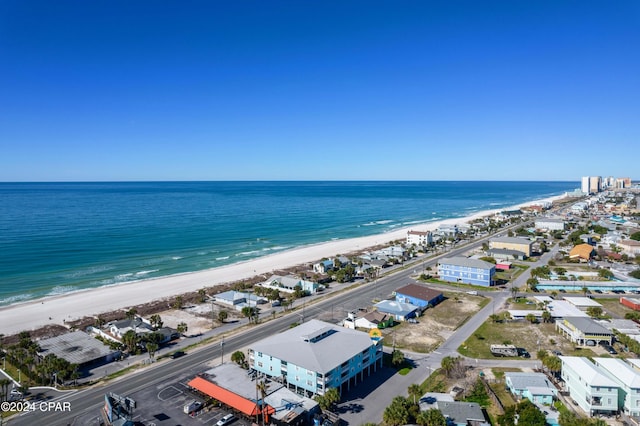 drone / aerial view featuring a water view and a view of the beach