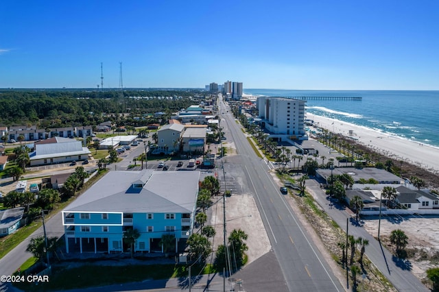 drone / aerial view featuring a beach view and a water view