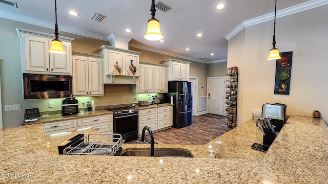 kitchen with black appliances, crown molding, and hanging light fixtures