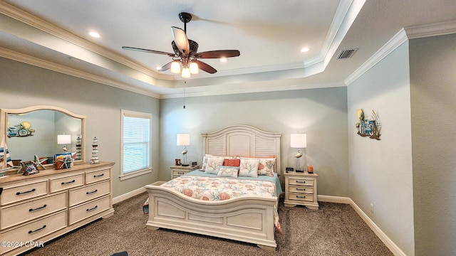 carpeted bedroom with ceiling fan, a raised ceiling, and ornamental molding