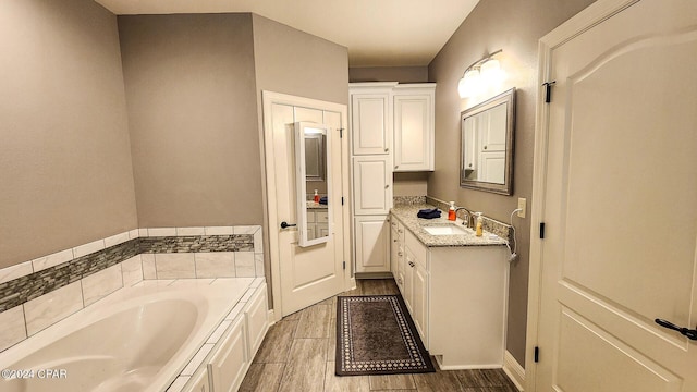 bathroom with a tub to relax in and vanity