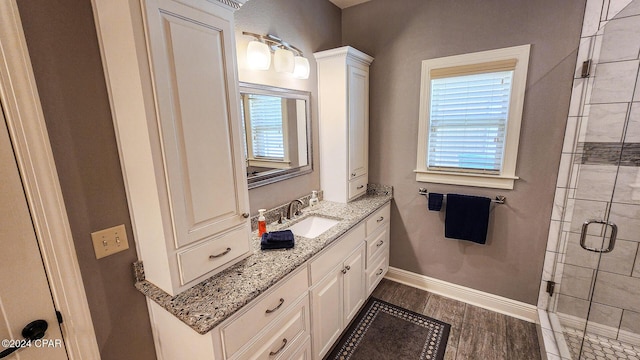 bathroom with vanity and a shower with shower door