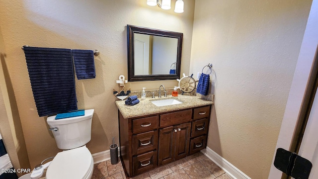 bathroom with tile patterned floors, vanity, and toilet