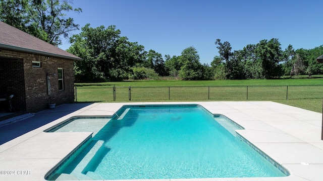 view of pool featuring a yard and a patio area