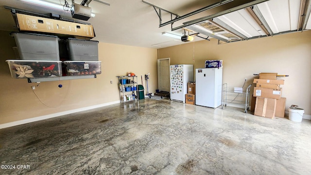 garage with white fridge and a garage door opener