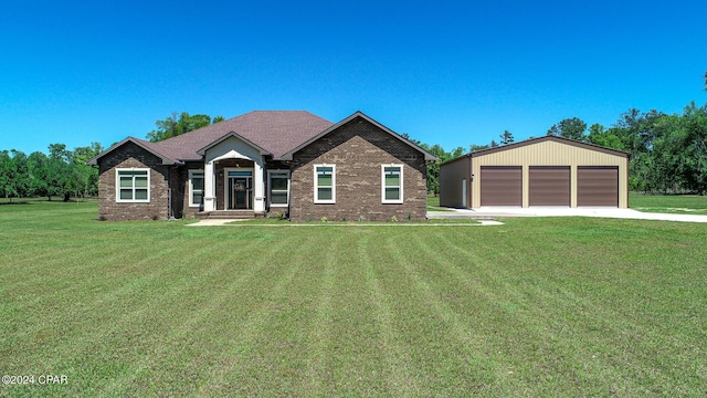 view of front of house featuring a front yard, an outbuilding, and a garage