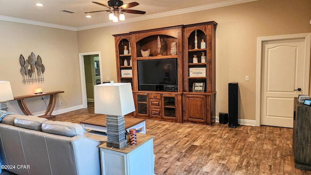 living room featuring hardwood / wood-style floors, ceiling fan, and crown molding