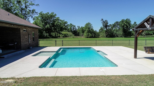 view of pool with a lawn and a patio