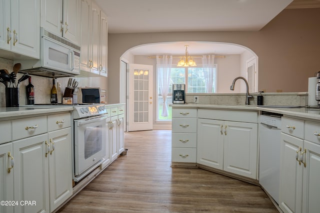 kitchen with light wood-type flooring, white appliances, and white cabinetry