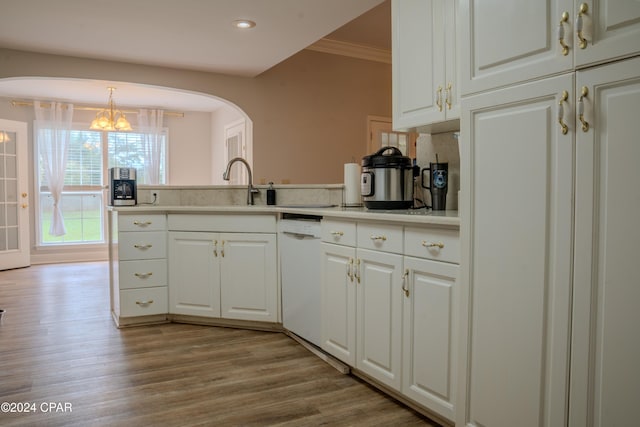 kitchen featuring dishwasher, white cabinetry, light hardwood / wood-style flooring, and ornamental molding