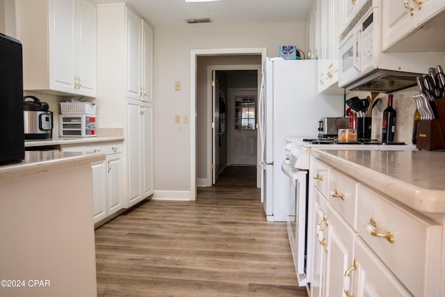 kitchen featuring light hardwood / wood-style floors, white appliances, and white cabinetry