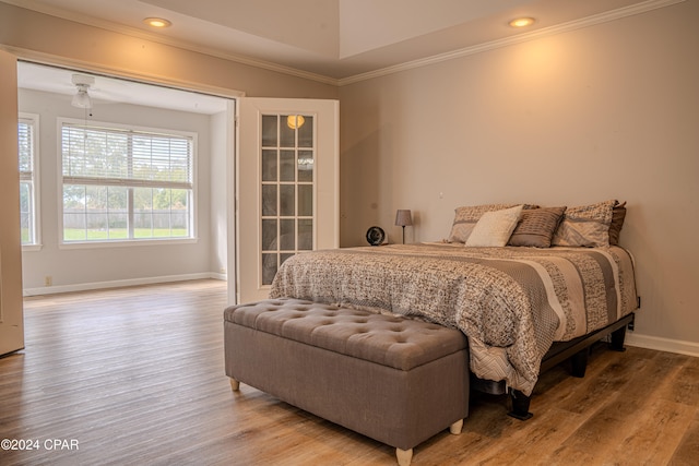 bedroom with hardwood / wood-style floors and crown molding