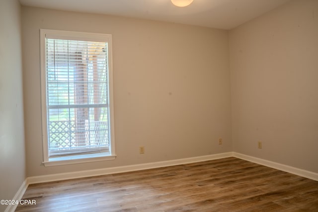 unfurnished room featuring hardwood / wood-style flooring