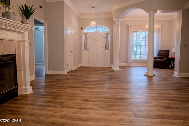 entryway featuring crown molding, a fireplace, and dark wood-type flooring