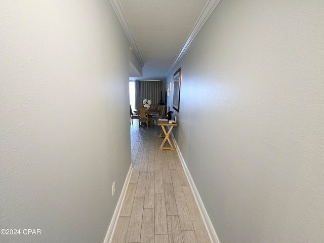 hall featuring wood-type flooring and ornamental molding