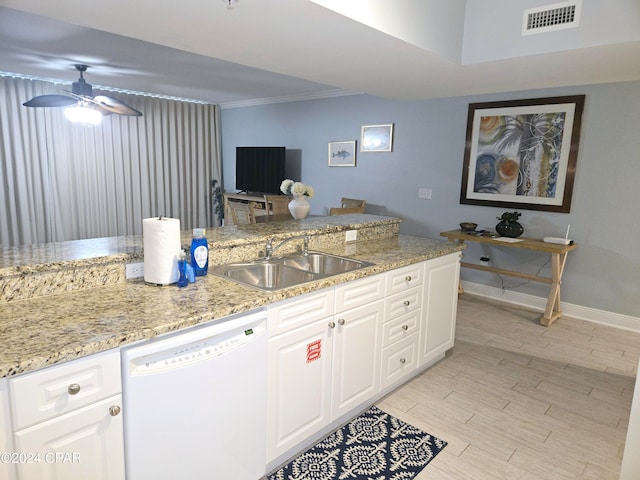 kitchen with dishwasher, white cabinets, light stone counters, and sink