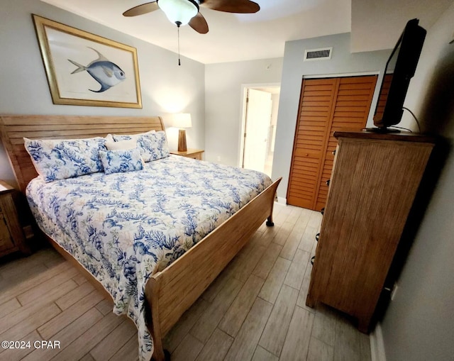 bedroom featuring ceiling fan, a closet, and light hardwood / wood-style floors