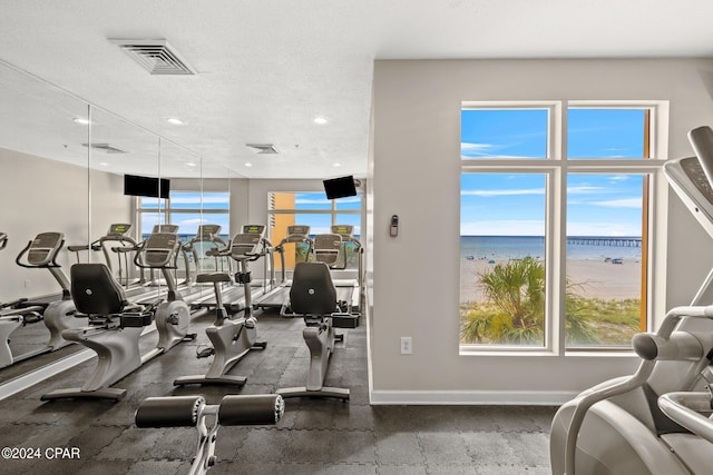 exercise room with a textured ceiling